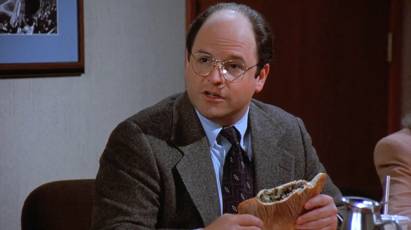 George Costanza holding a calzone.