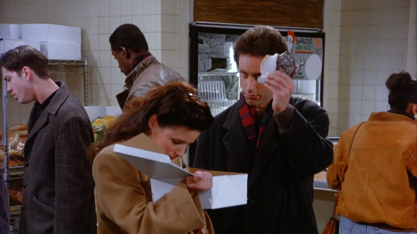 Jerry holding up a black and white cookie.